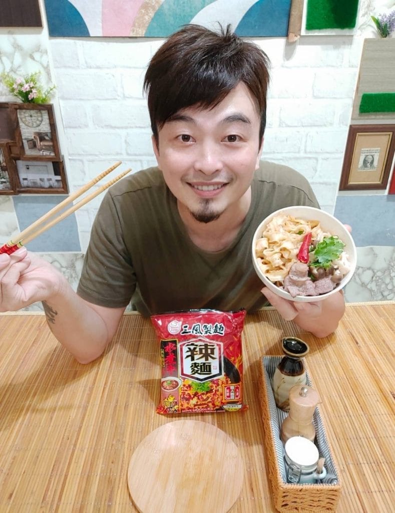 一名男子展示手上的乾拌麵